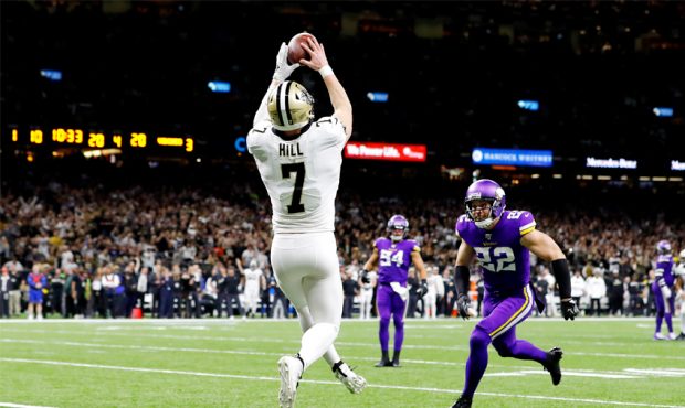 Taysom Hill #7 of the New Orleans Saints scores a 20-yard receiving touchdown during the fourth qua...
