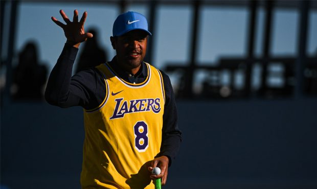 Tony Finau pretends to shoot a basketball while wearing a Kobe Bryant jersey on the 16th green duri...
