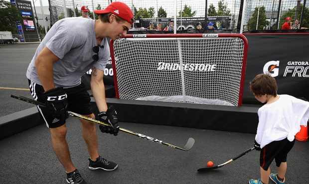Nico Hischier instructs a child during the 2017 NHL Draft top prospects hockey clinic and media ava...