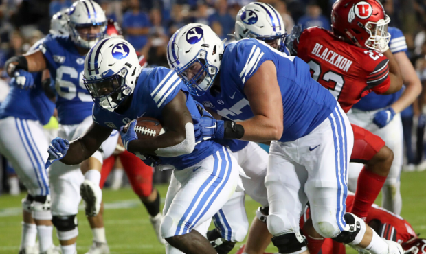 BYU offensive lineman Brady Christensen (67) pushes running back Ty'Son Williams (5) over the goal ...