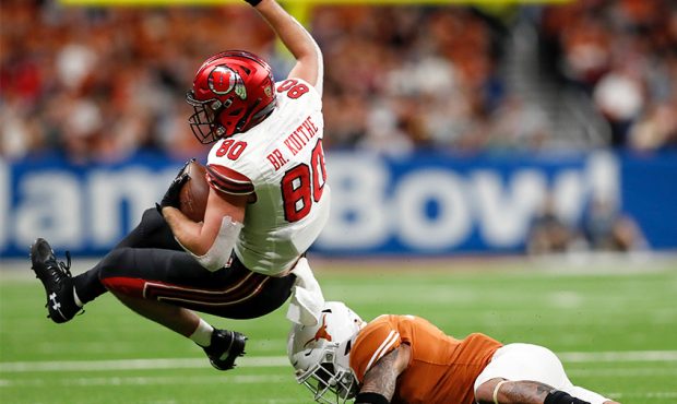 Brant Kuithe #80 of the Utah Utes is tackled by Caden Sterns #7 of the Texas Longhorns in the third...