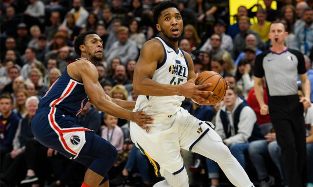 Donovan Mitchell #45 of the Utah Jazz drives past Ish Smith #14 of the Washington Wizards during a ...