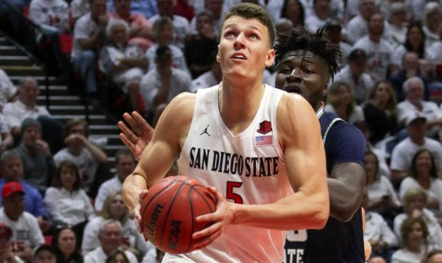 Yanni Wetzell #5 of the San Diego State Aztecs drives to the basket with the ball in the first half...