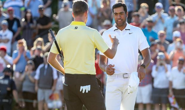 Webb Simpson (L) shakes hands with Tony Finau after defeating him on the first playoff hole during ...