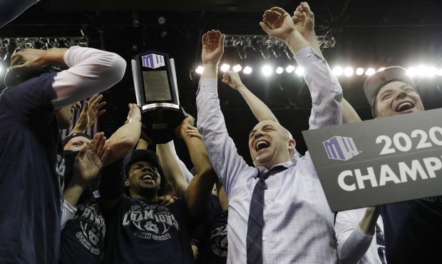 LAS VEGAS, NEVADA - MARCH 07: Head coach Craig Smith of the Utah State Aggies celebrates with his t...