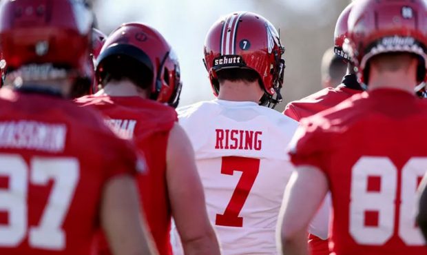 Quarterback Cameron Rising and other players circle up as head coach Kyle Whittingham calls the tea...