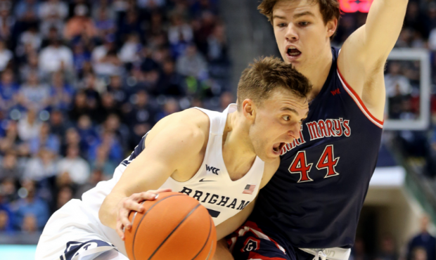 BYU Cougars guard Jake Toolson (5) drives on Saint Mary's Gaels guard Alex Ducas (44) as the teams ...