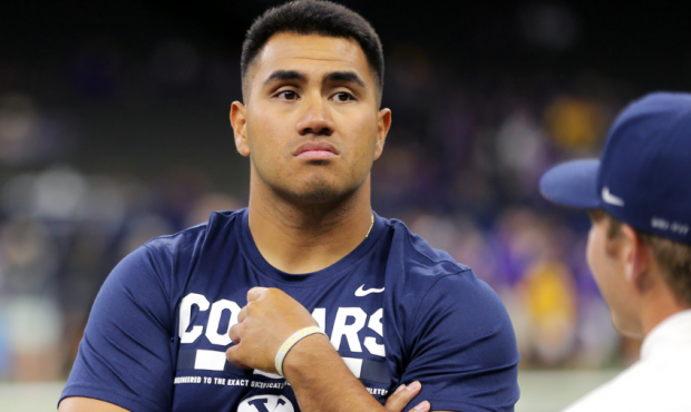 Former BYU player Harvey Unga watches pregame preparations as BYU and LSU prepare to play in the Me...