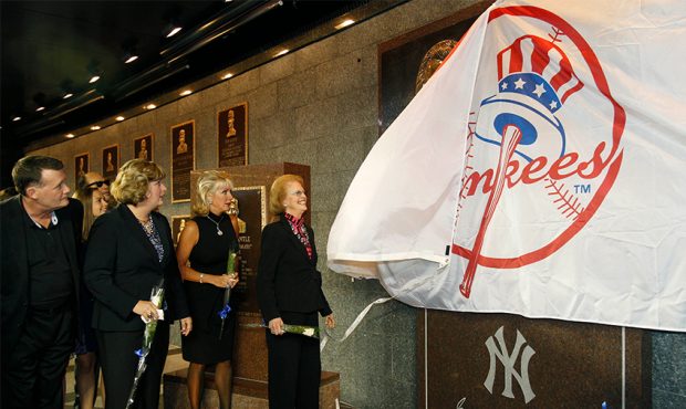 Members of the Steinbrenner family watch as Steinbrenner's widow Joan pulls a Yankees banner down t...