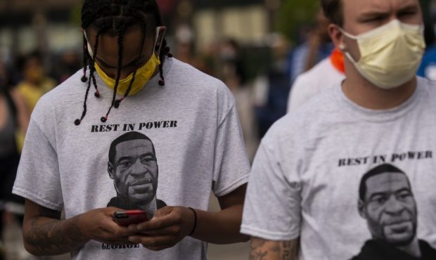 Two men wear shirts stating "Rest in Power George Floyd" (Photo by Stephen Maturen/Getty Images)...