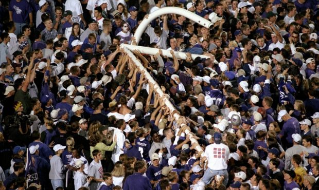 Kansas State Wildcat fans celebrate a victory over the Nebraska Cornhuskers by pulling the goal pos...