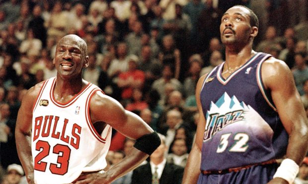 Karl Malone stands next to Michael Jordan...