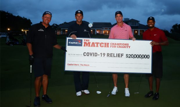 Tiger Woods and former NFL player Peyton Manning celebrate defeating Phil Mickelson and NFL player ...