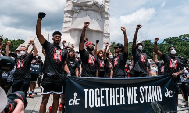 Members of the Washington Wizards and Washington Mystics basketball teams rally at the MLK Memorial...