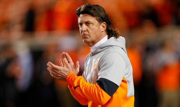 Head coach Mike Gundy of the Oklahoma State Cowboys encourages his team before a "Bedlam" game agai...