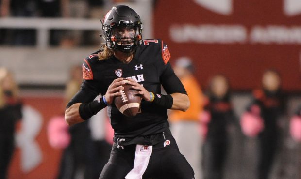 Quarterback Travis Wilson #7 of the Utah Utes looks down field during their game against the USC Tr...