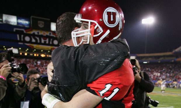 Quarterback Alex Smith #11 of Utah hugs head coach Urban Meyer after Utah defeated Pittsburgh 35-7 ...