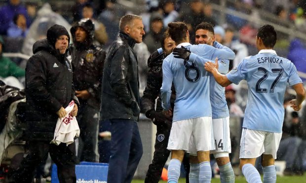 Dom Dwyer #14 of Sporting Kansas City celebrates with coaches and teammates after scoring a goal du...