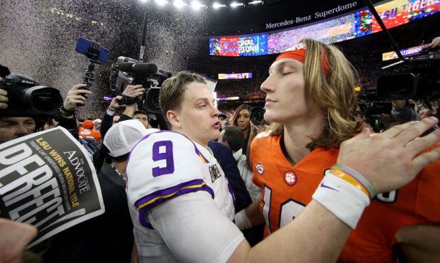 Joe Burrow #9 of the LSU Tigers talks with Trevor Lawrence #16 of the Clemson Tigers after their 42...