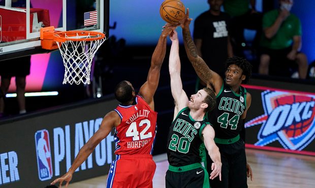 Al Horford #42 of the Philadelphia 76ers competes for a rebound against Gordon Hayward #20 and Robe...