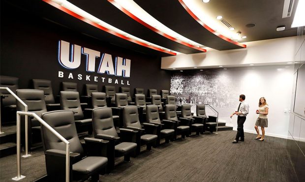 People tour the men's basketball film room during the opening of the Jon M. and Karen Huntsman Bask...