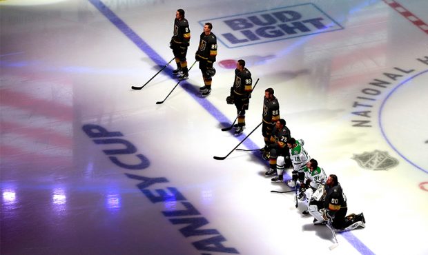 EDMONTON, ALBERTA - AUGUST 03: Players from the Vegas Golden Knights and the Dallas Stars kneel as ...