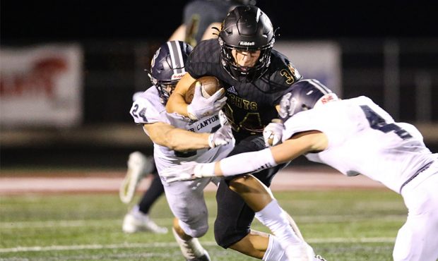 Lone Peak running back Jaxson Willits (34) carries the ball against the Corner Canyon defense durin...