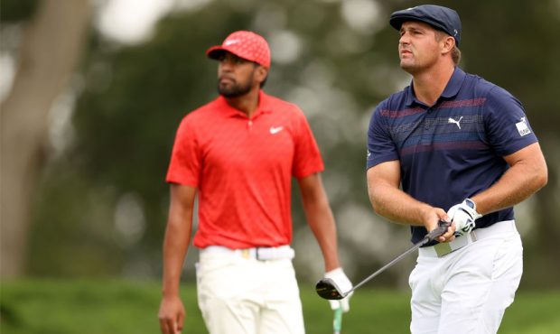 Bryson DeChambeau of the United States and Tony Finau of the United States look on from the sixth t...