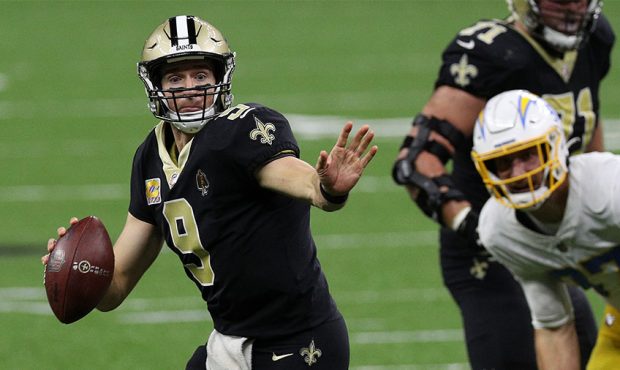 Drew Brees #9 of the New Orleans Saints scrambles with the ball against the Los Angeles Chargers du...