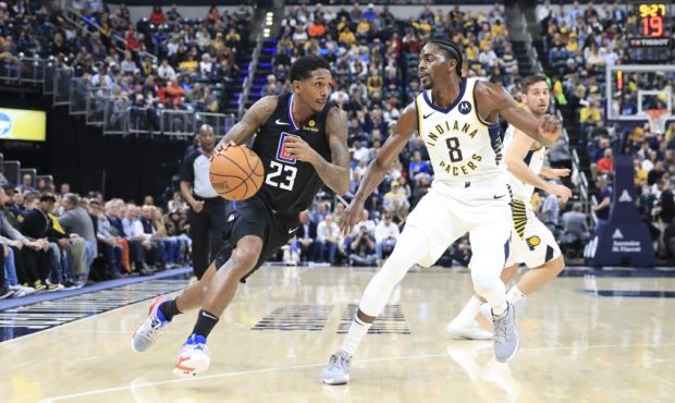 Lue Williams of the Clippers and Justin Holiday of the Pacers (Photo by Andy Lyons/Getty Images)...