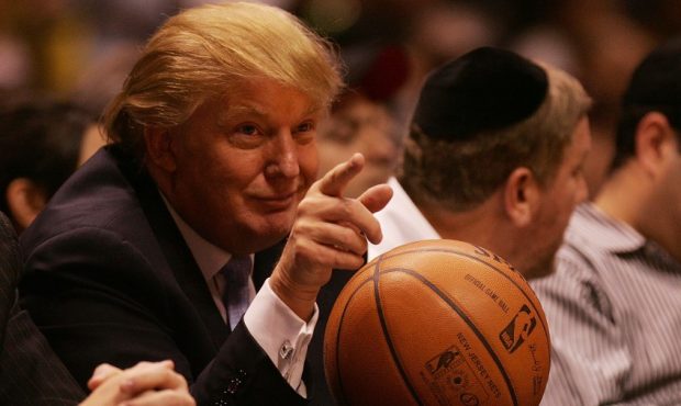 Future President Donald Trump sits courtside at an NBA game.. (Photo by Nick Laham/Getty Images)...