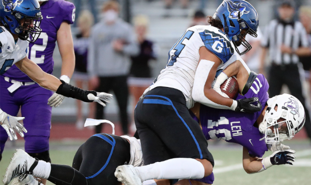 Pleasant Grove’s Isaac Vaha tackles Lehi’s Chandler Jenkins during a football game at Lehi High...