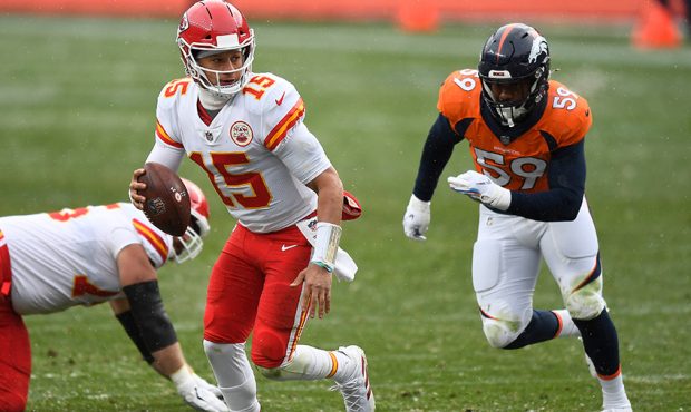 Patrick Mahomes #15 of the Kansas City Chiefs looks to pass against the Denver Broncos in the third...