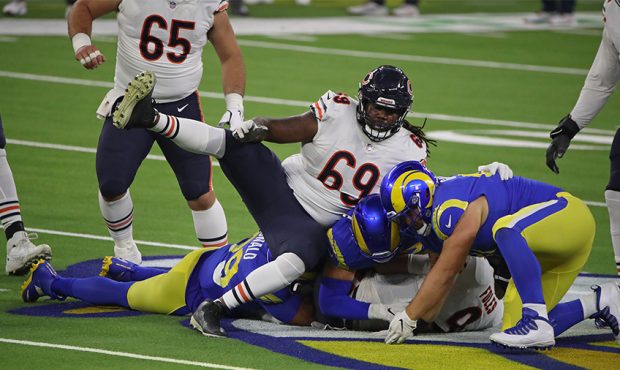Nick Foles #9 of the Chicago Bears is tackled by Aaron Donald #99 and Greg Gaines #91 of the Los An...
