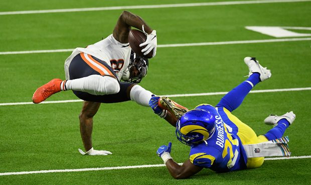 Wide receiver Cordarrelle Patterson #84 of the Chicago Bears is tripped up by safety Terrell Burges...