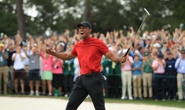 Tiger Woods (L) of the United States celebrates on the 18th green after winning the Masters at Augu...