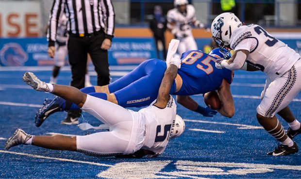 Utah State's Cash Gilliam (5) and Kevin Meitzenheimer combine on a tackle against Boise State on Sa...