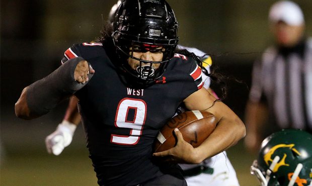 West High’s 9 Johnny Alo gains yardage in the game against Kearns at West High School in Salt Lak...