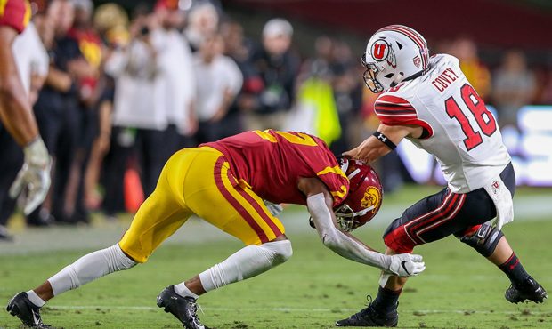 Utah Utes wide receiver Britain Covey (18) catches the ball and get tackled by USC Trojans cornerba...