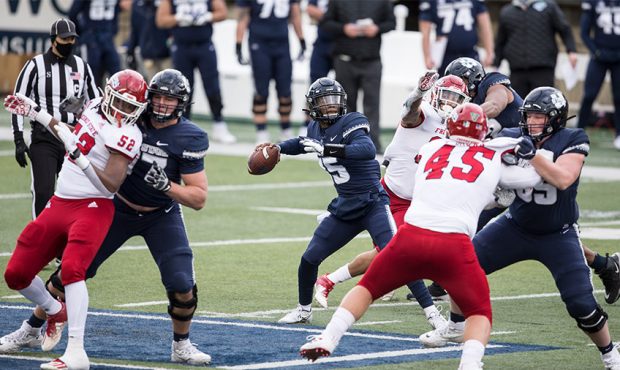 Quarterback Jason Shelley #15 of the Utah State Aggies throws from a busy pocket against the Fresno...