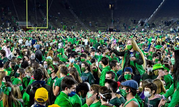 Fans storm the field after the Notre Dame Fighting Irish defeated the Clemson Tigers 47-40 in doubl...