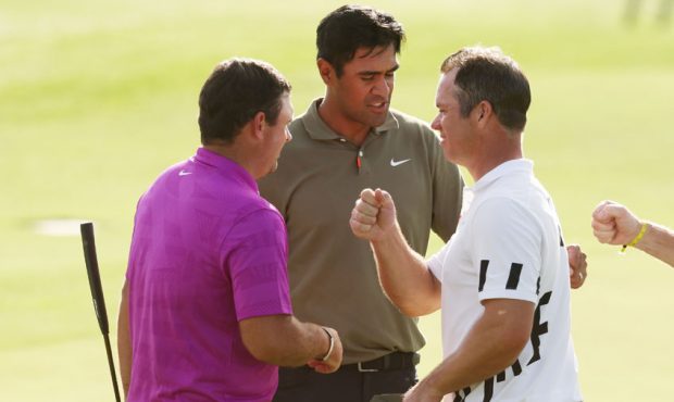Paul Casey of England, Tony Finau of United States and Patrick Reed of the United States shake hand...