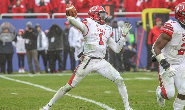 Utah Utes quarterback Tyler Huntley (1) passes during the Zaxby's Heart of Dallas Bowl game between...