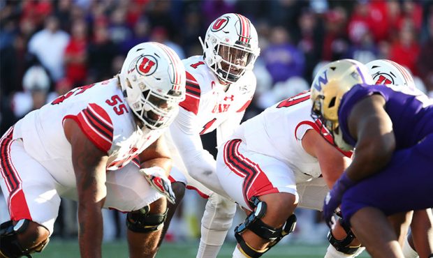 Tyler Huntley #1 of the Utah Utes calls out plays in the fourth quarter against the Washington Husk...