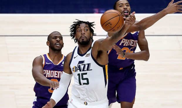 Utah Jazz center Derrick Favors (15) reaches for the ball in front of Phoenix Suns guard Chris Paul...
