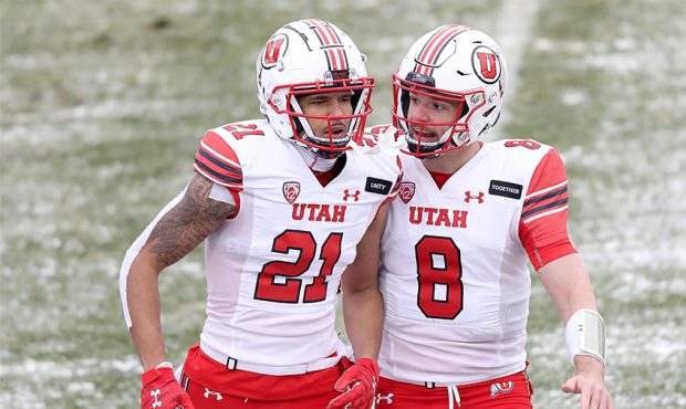 Wide receiver Solomon Enis #21 and quarterback Jake Bentley #8 of the Utah Utes celebrate a touchdo...
