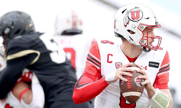 Quarterback Jake Bentley #8 of the Utah Utes rolls out of the pocket against the Colorado Buffaloes...