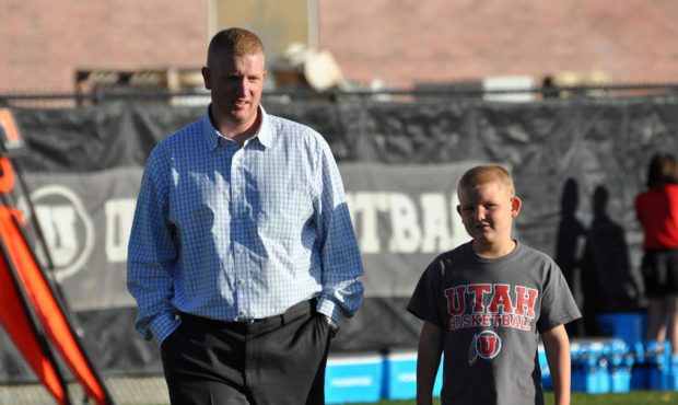 University of Utah Deputy Athletics Director Kyle Brennan shown walking with son Mac at the Univers...