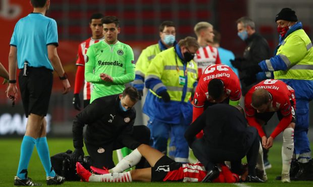 Richard Ledezma of PSV Eindhoven is treated by medical staff after sustaining an injury during the ...