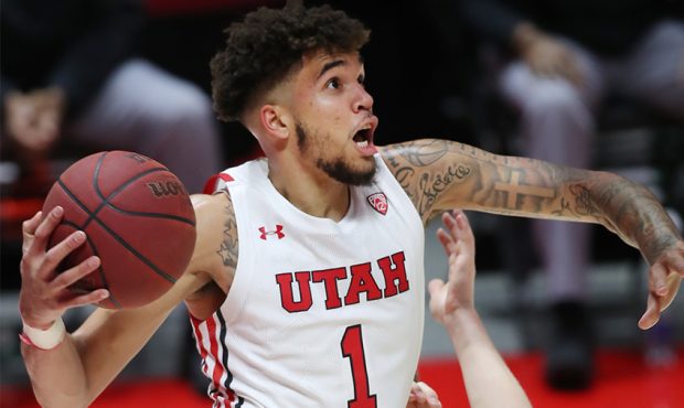 Utah Utes forward Timmy Allen (1) tries to go up for a shot under the hoop as the University of Uta...